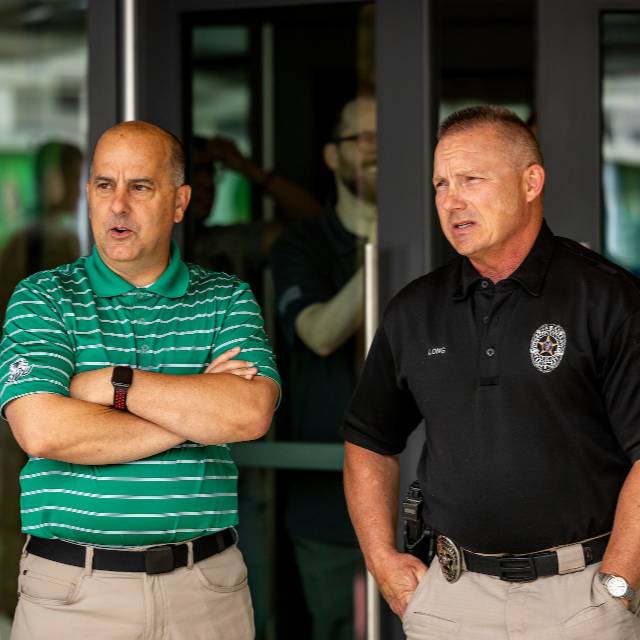 Two people in front of a building