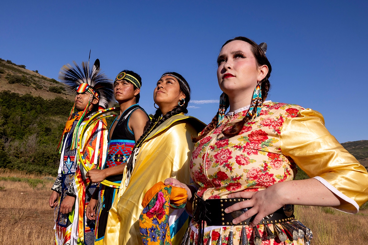 Students and staff from UVU’s Native American Initiative smile for a group photo on steps on UVU’s Orem Campus. 